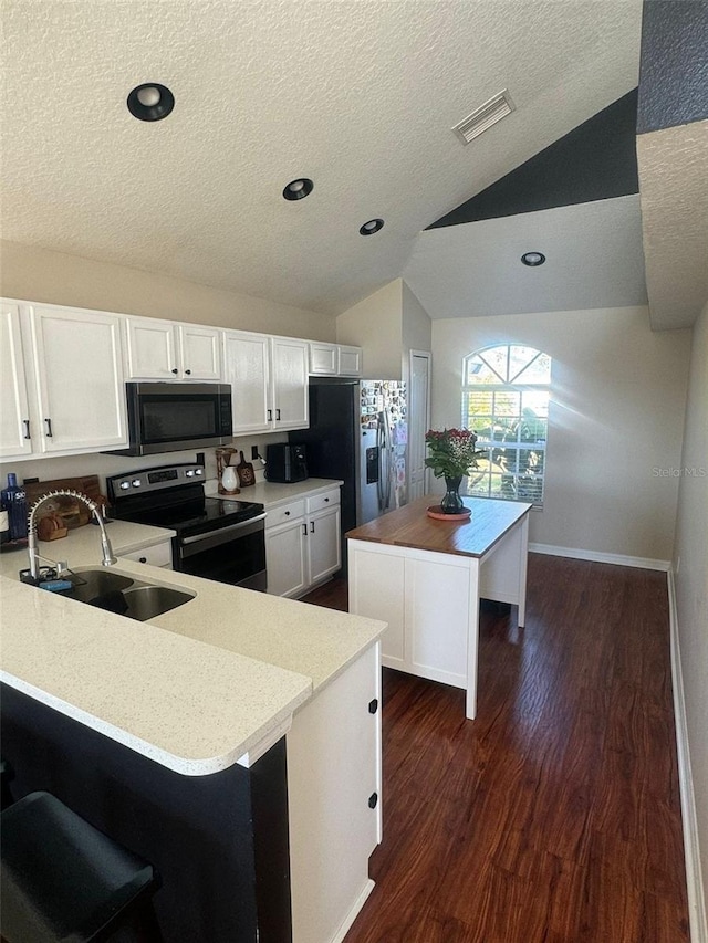 kitchen with white cabinetry, sink, a kitchen island, and appliances with stainless steel finishes