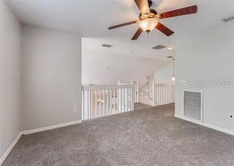 spare room featuring carpet floors and ceiling fan