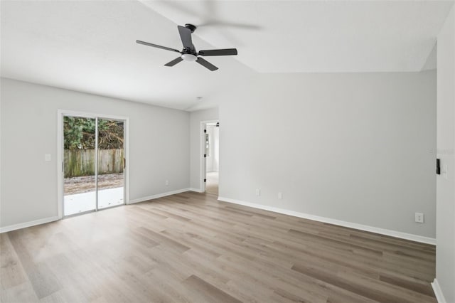 spare room featuring lofted ceiling, light hardwood / wood-style floors, and ceiling fan