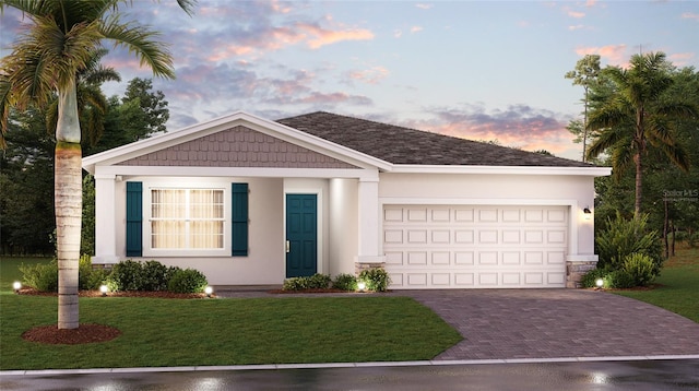 view of front of property featuring a garage and a lawn