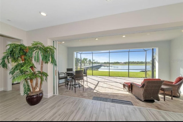 interior space featuring a water view, a wealth of natural light, and light hardwood / wood-style floors