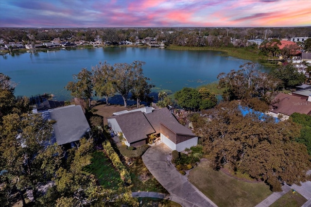 aerial view at dusk with a water view