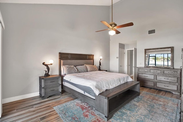 bedroom featuring high vaulted ceiling, dark wood-type flooring, and ceiling fan