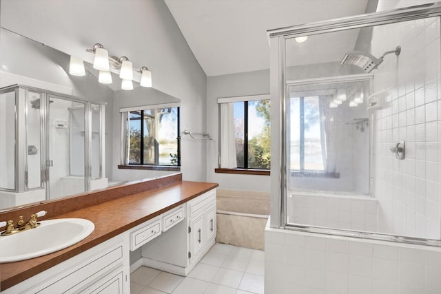 bathroom with tile patterned floors, vanity, separate shower and tub, and vaulted ceiling