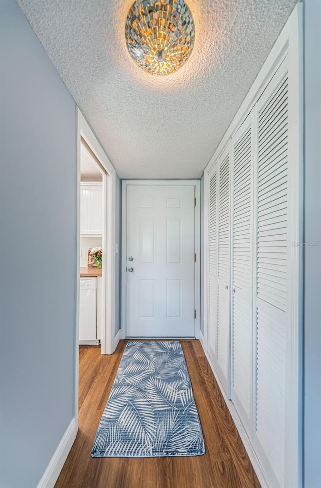 hall featuring hardwood / wood-style floors and a textured ceiling