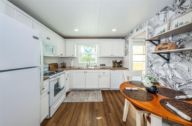 kitchen with white cabinetry, sink, dark wood-type flooring, wooden ceiling, and white appliances