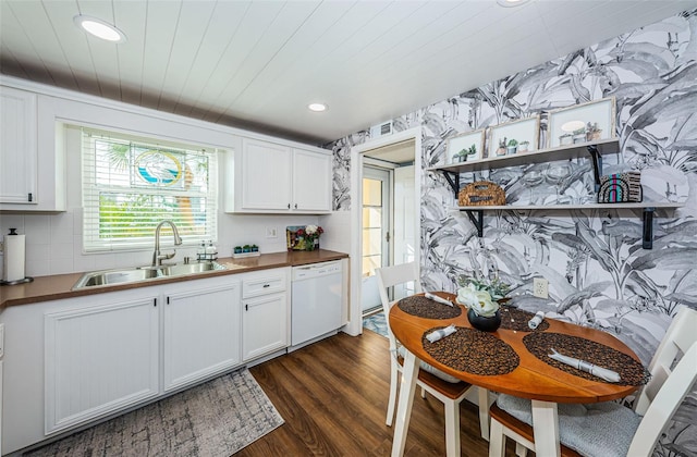 kitchen featuring white cabinetry, white dishwasher, sink, and dark wood-type flooring