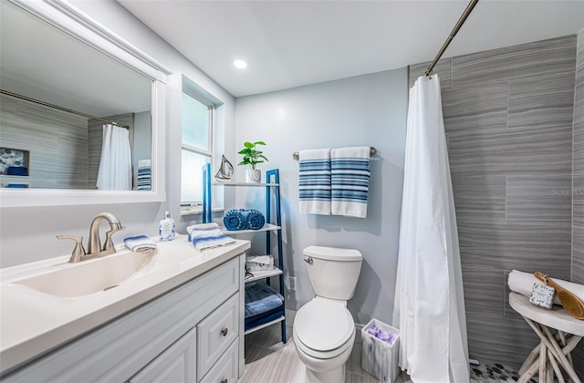 bathroom with vanity, toilet, and curtained shower