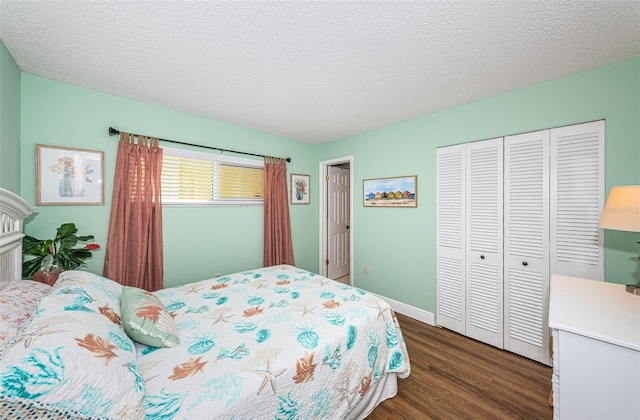 bedroom with a textured ceiling, dark hardwood / wood-style flooring, and a closet