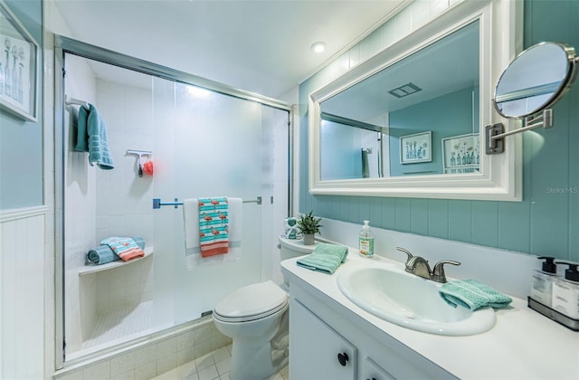 bathroom with an enclosed shower, vanity, and toilet