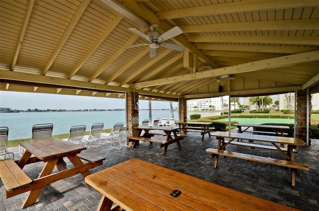 surrounding community with a water view and a gazebo