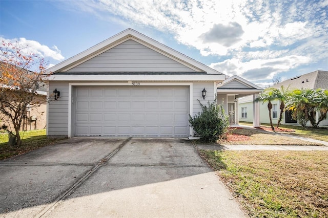 single story home featuring driveway and a garage