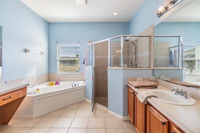 bathroom with vanity, tile patterned floors, and plus walk in shower