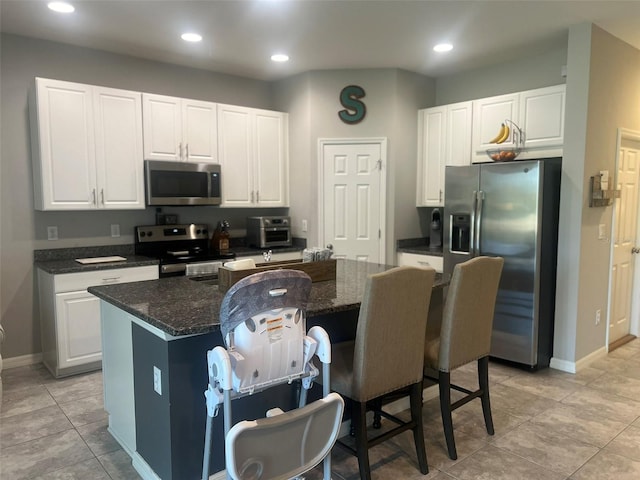 kitchen featuring white cabinetry, a center island, and appliances with stainless steel finishes