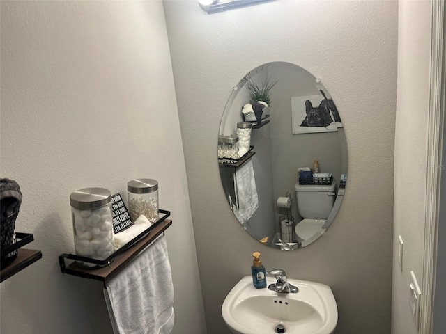 bathroom featuring sink and toilet