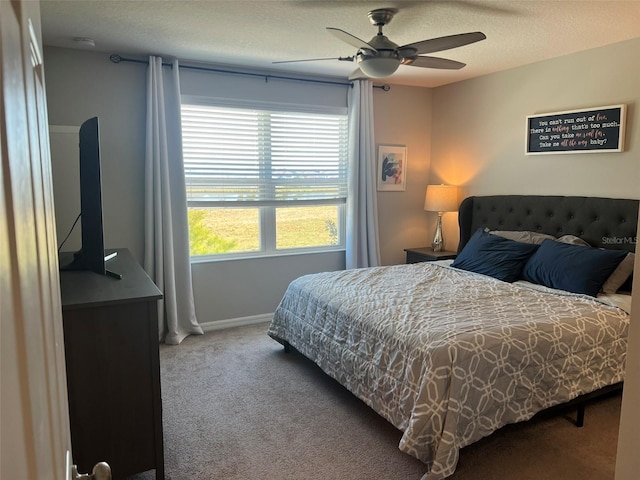 bedroom featuring ceiling fan, a textured ceiling, and carpet flooring