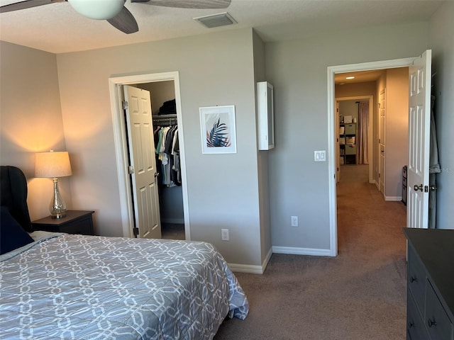 bedroom featuring ceiling fan, a walk in closet, carpet floors, and a closet