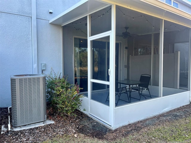 view of home's exterior with central AC and a sunroom