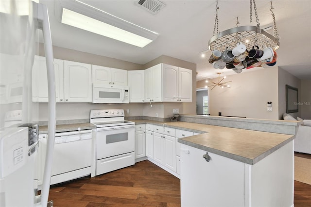 kitchen featuring white appliances, dark hardwood / wood-style floors, kitchen peninsula, and white cabinets