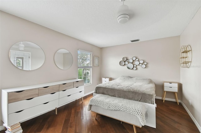 bedroom with dark wood-type flooring and a textured ceiling