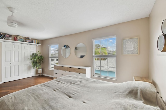 bedroom featuring dark wood-type flooring and a textured ceiling