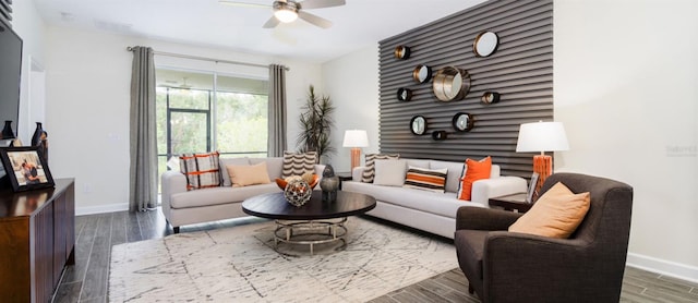 living room with ceiling fan and dark hardwood / wood-style flooring