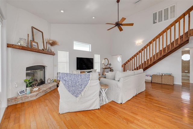 living room with hardwood / wood-style flooring and ceiling fan