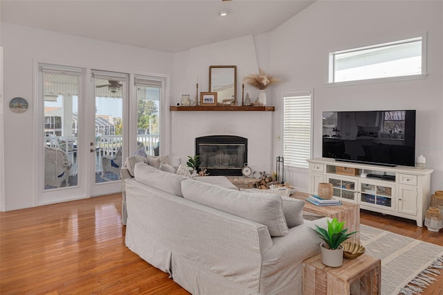 living room featuring vaulted ceiling and light wood-type flooring