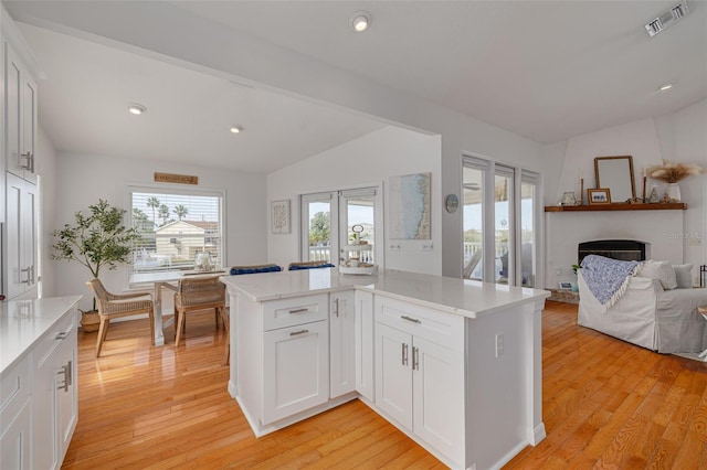 kitchen with white cabinetry, kitchen peninsula, and light wood-type flooring