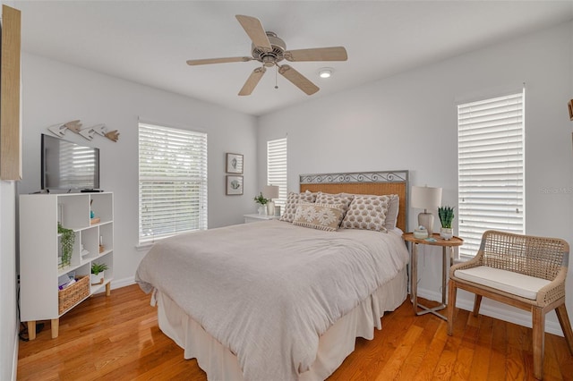 bedroom with ceiling fan and light hardwood / wood-style floors