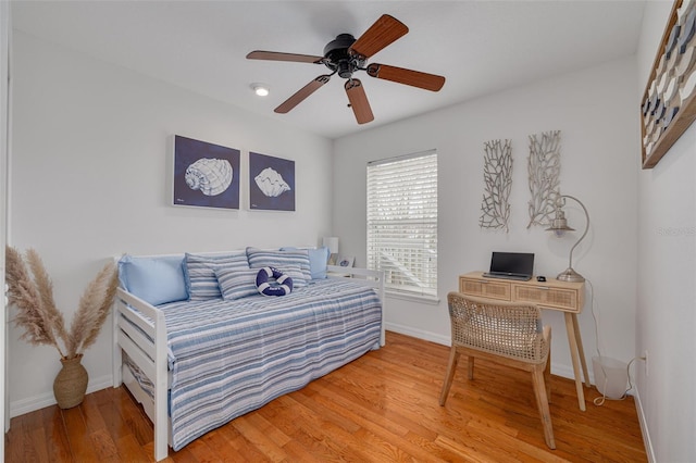 bedroom featuring hardwood / wood-style flooring and ceiling fan