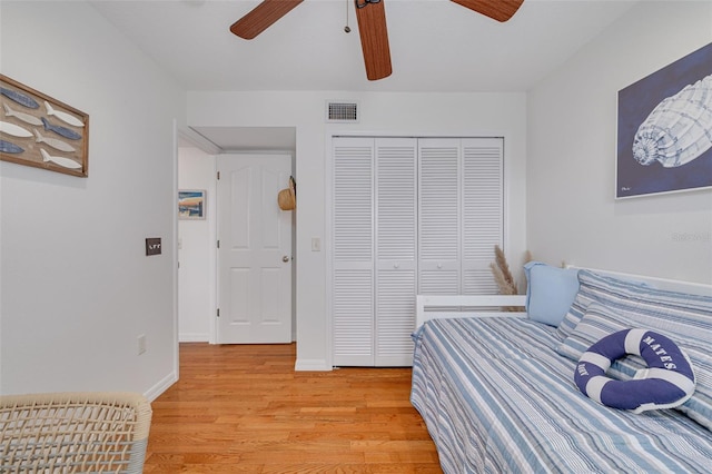 bedroom with a closet, ceiling fan, and light wood-type flooring