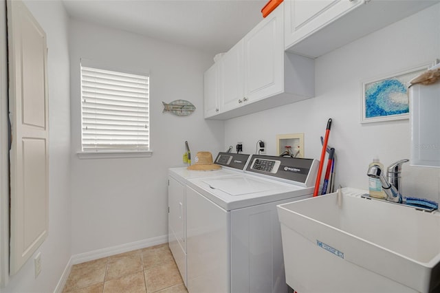 laundry area with cabinets, washer and dryer, sink, and light tile patterned floors