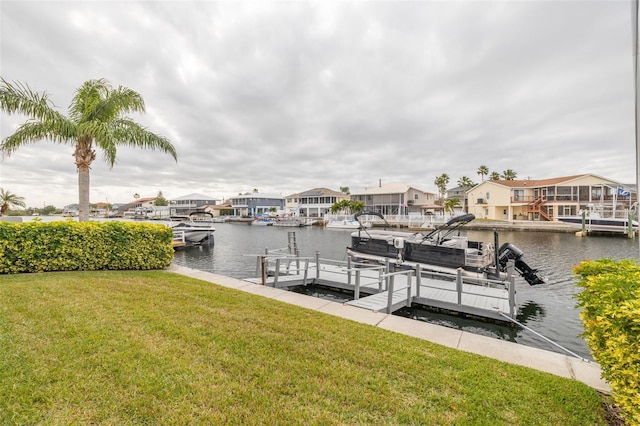 dock area featuring a water view and a lawn