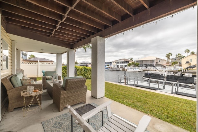 view of patio / terrace featuring a water view, a dock, and outdoor lounge area