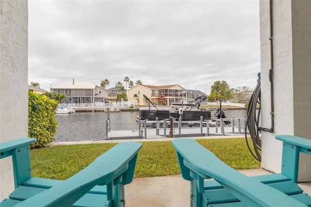 view of patio / terrace featuring a water view and a dock