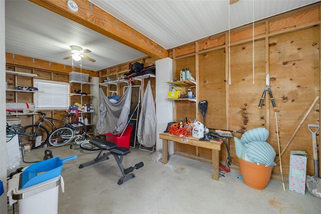 interior space featuring concrete floors, ceiling fan, and a workshop area