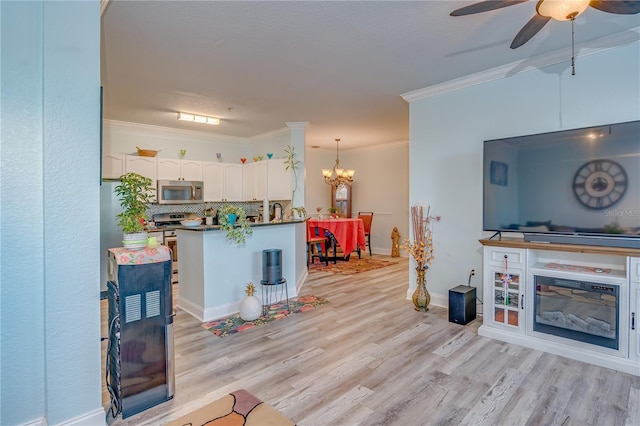 kitchen with white cabinetry, ornamental molding, pendant lighting, stainless steel appliances, and light hardwood / wood-style floors