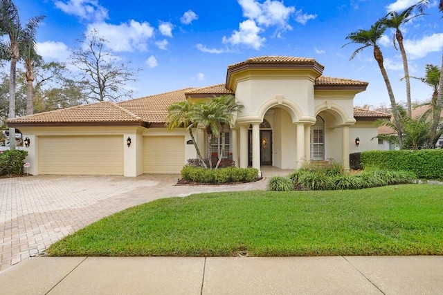 2867 Grey Oaks Blvd, Tarpon Springs, FL 34688 - mediterranean / spanish house featuring a garage and a front lawn