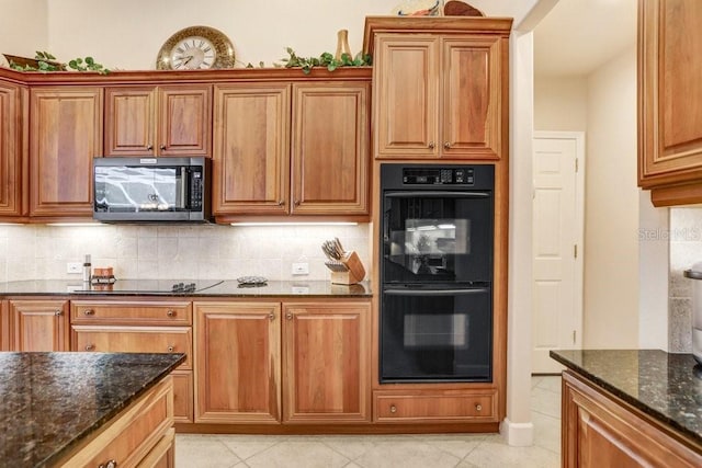 2867 Grey Oaks Blvd, Tarpon Springs, FL 34688 - kitchen with tasteful backsplash, light tile patterned floors, dark stone counters, and black appliances