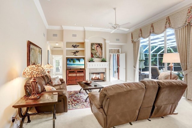 2867 Grey Oaks Blvd, Tarpon Springs, FL 34688 - living room featuring ceiling fan, a multi sided fireplace, crown molding, and light colored carpet