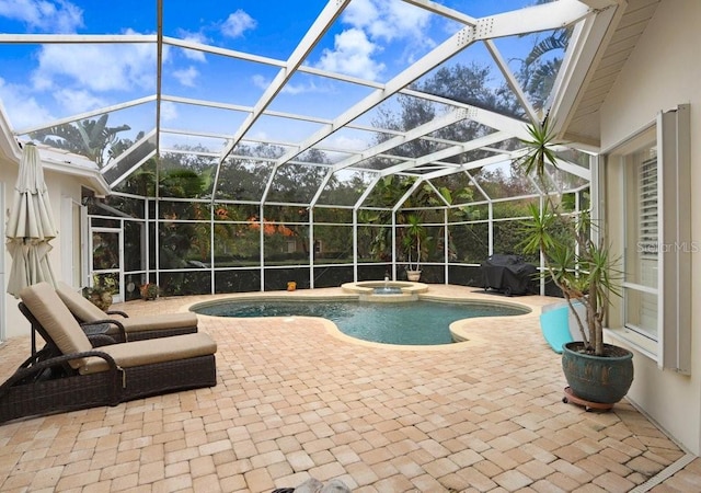 2867 Grey Oaks Blvd, Tarpon Springs, FL 34688 - view of pool featuring an in ground hot tub, area for grilling, glass enclosure, and a patio