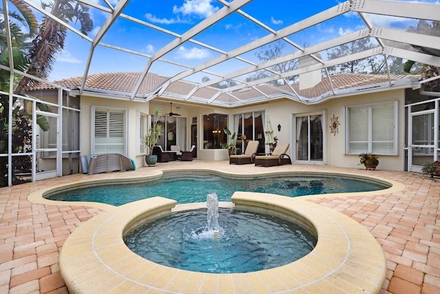 2867 Grey Oaks Blvd, Tarpon Springs, FL 34688 - view of pool featuring a lanai, an outdoor hangout area, a patio, and an in ground hot tub
