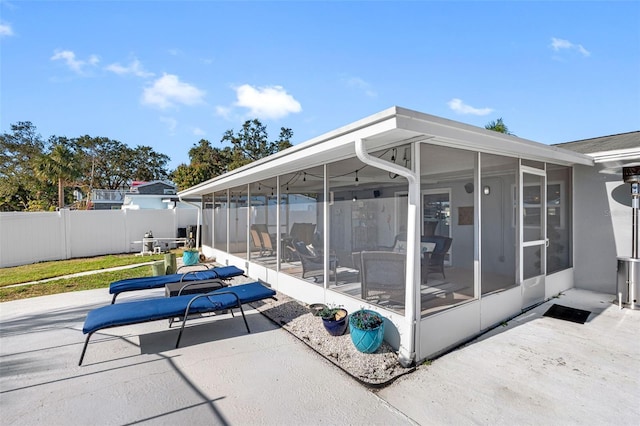 view of patio featuring a sunroom