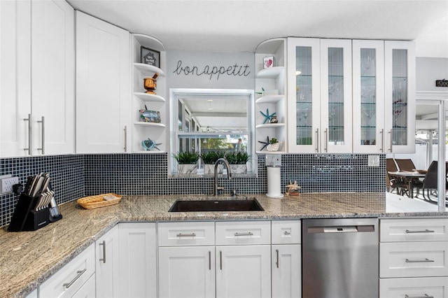 kitchen with white cabinetry, sink, tasteful backsplash, and stainless steel dishwasher