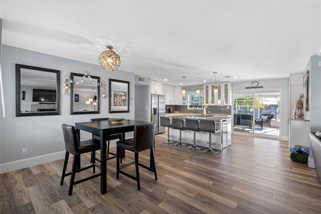 dining area featuring dark wood-type flooring