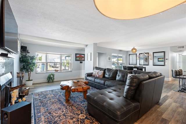 living room with hardwood / wood-style floors and a textured ceiling