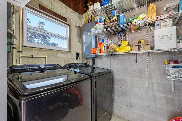 clothes washing area with washing machine and dryer