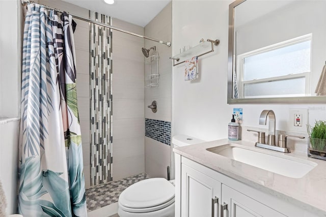 bathroom featuring vanity, toilet, and a shower with shower curtain