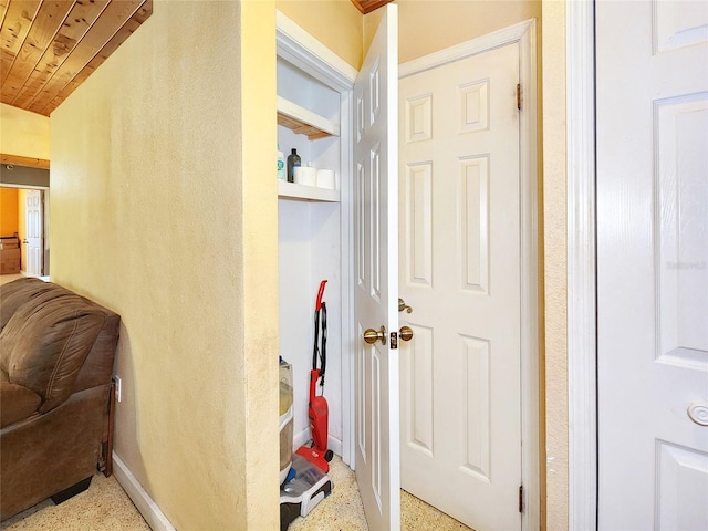 hall featuring speckled floor